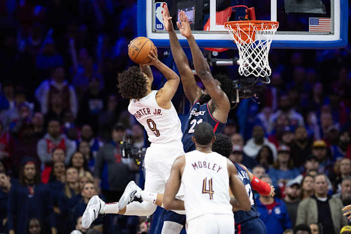 Nov 21, 2023; Philadelphia, Pennsylvania, USA; Cleveland Cavaliers guard Craig Porter (9) drives for a score against Philadelphia 76ers center Joel Embiid (21) during overtime at Wells Fargo Center.
